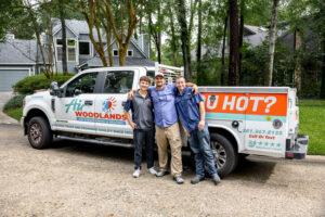 Air Woodlands owner and technicians standing in front of branded service truck in The Woodlands TX